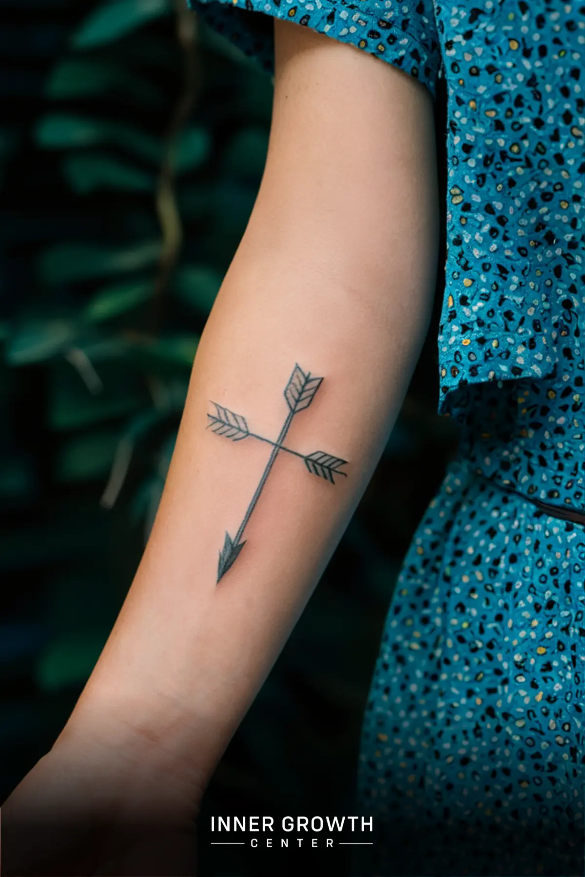 An arrow tattoo on an arm.