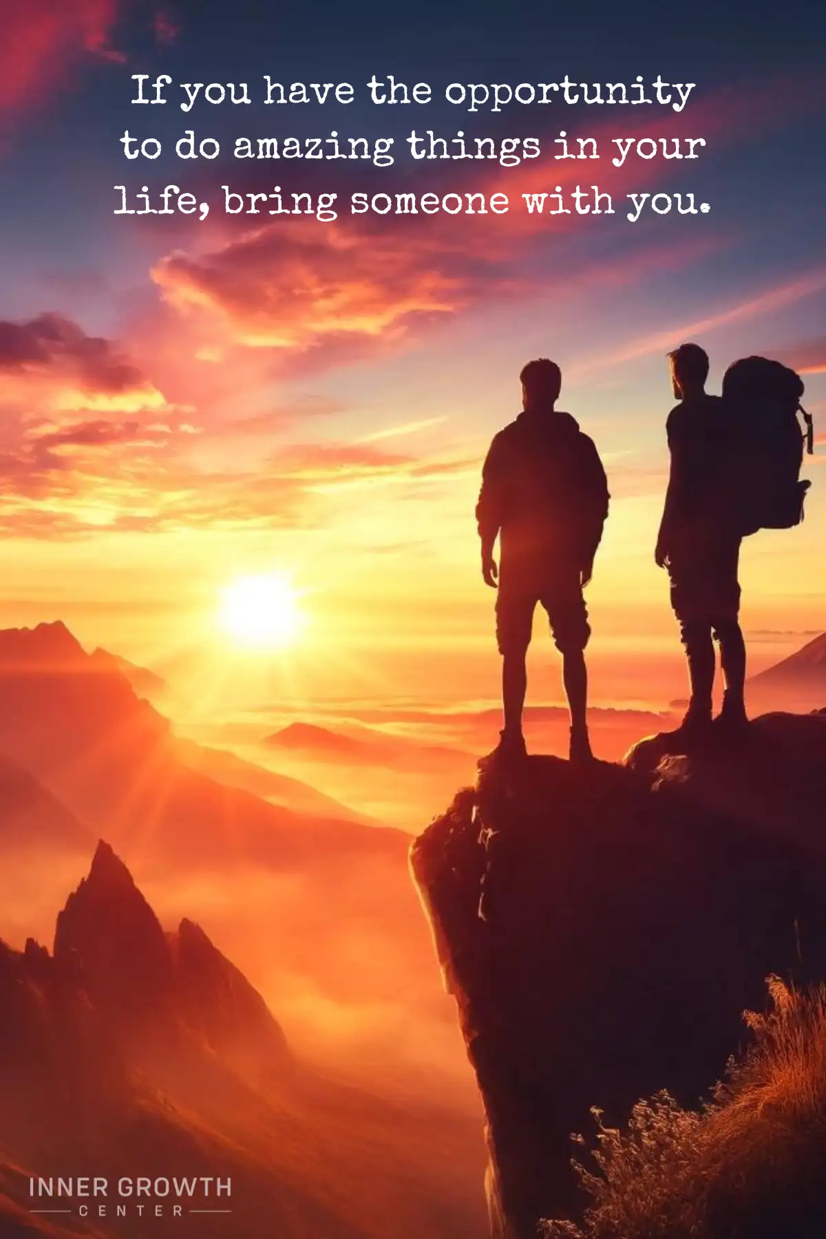 Two friends standing on a cliff looking at the sunrise.