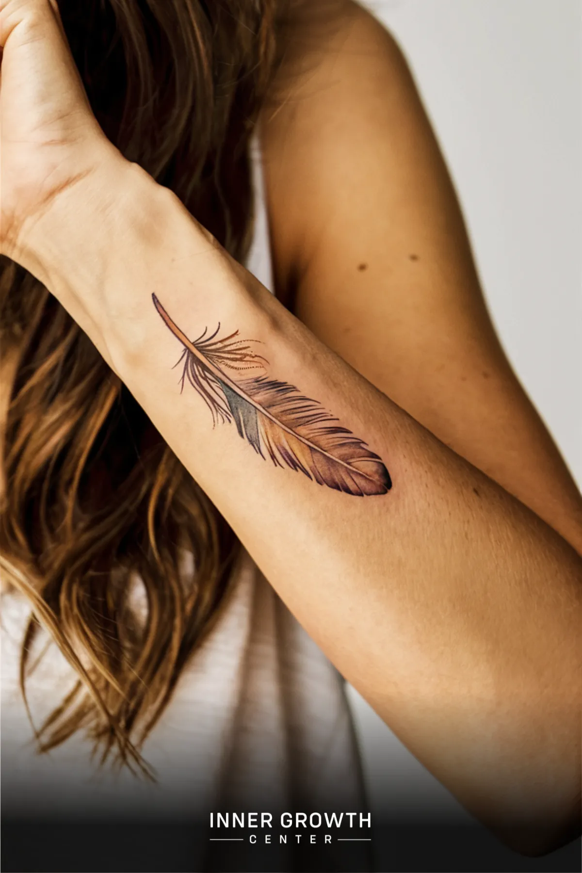 A feather tattoo on a woman's arm.