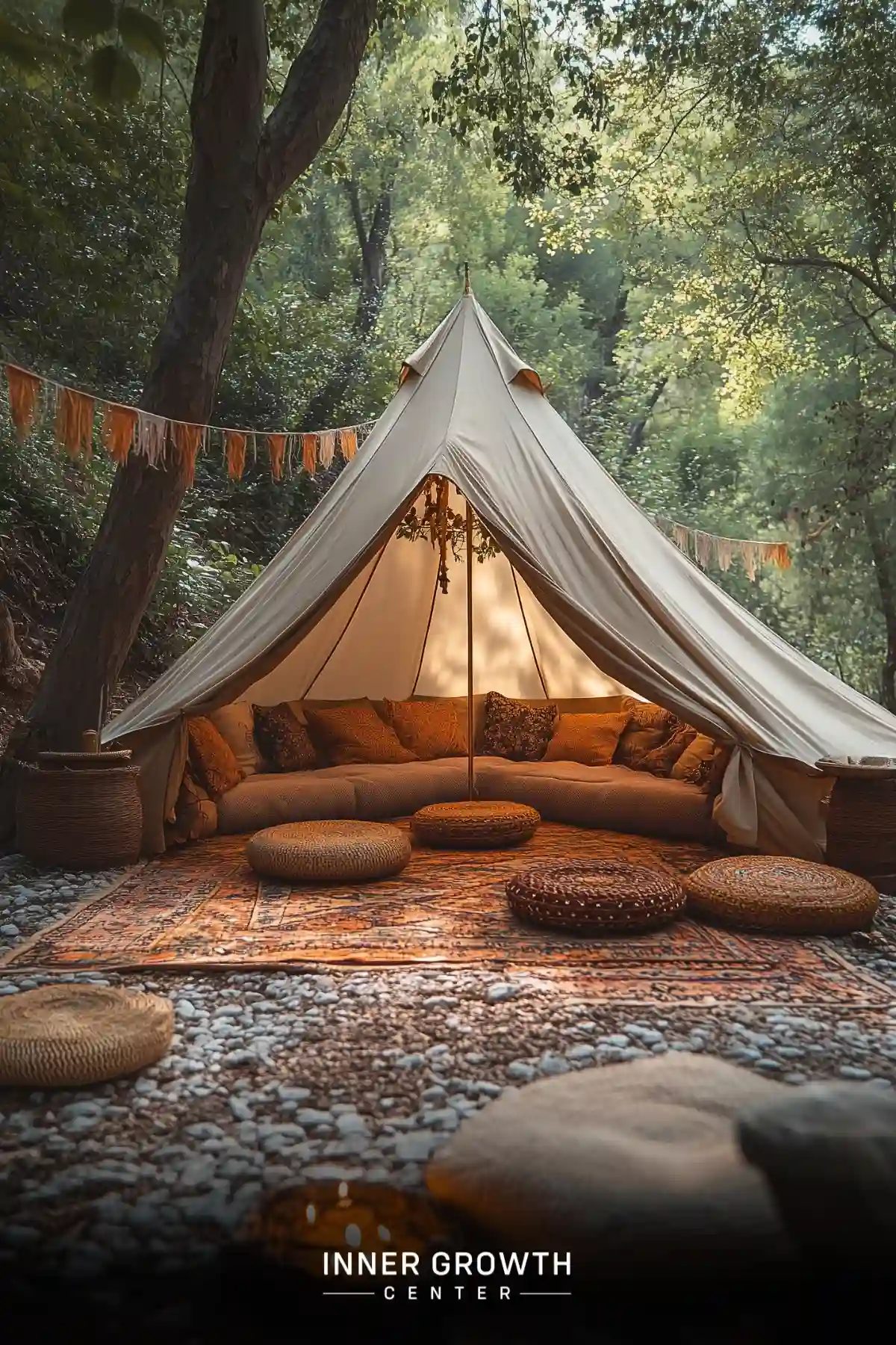 A cozy bell tent in a forest setting, decorated with cushions and rugs for outdoor meditation.