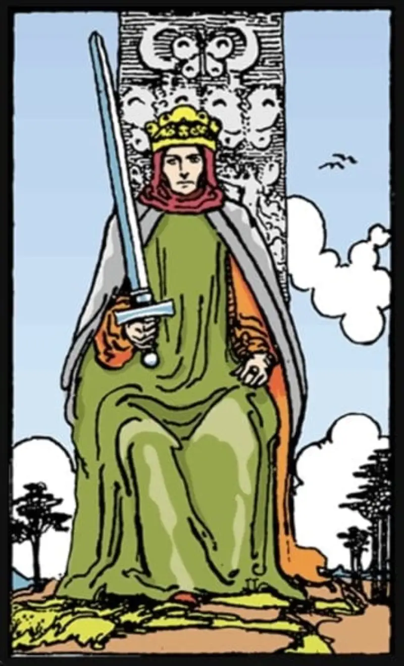 A king sitting on a throne with a sword as the king of swords tarot card.