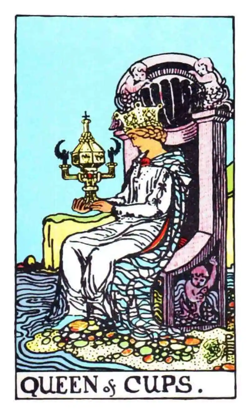 A queen sits on a throne holding a cup, as the queen of cups tarot card.