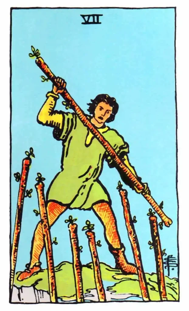 A man in a fighting position holds a wand with 6 others around as the seven of wands tarot card.