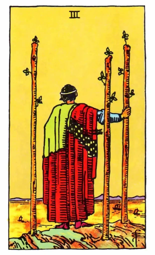 A 3 of Wands tarot card depicting a man standing in front of three trees.